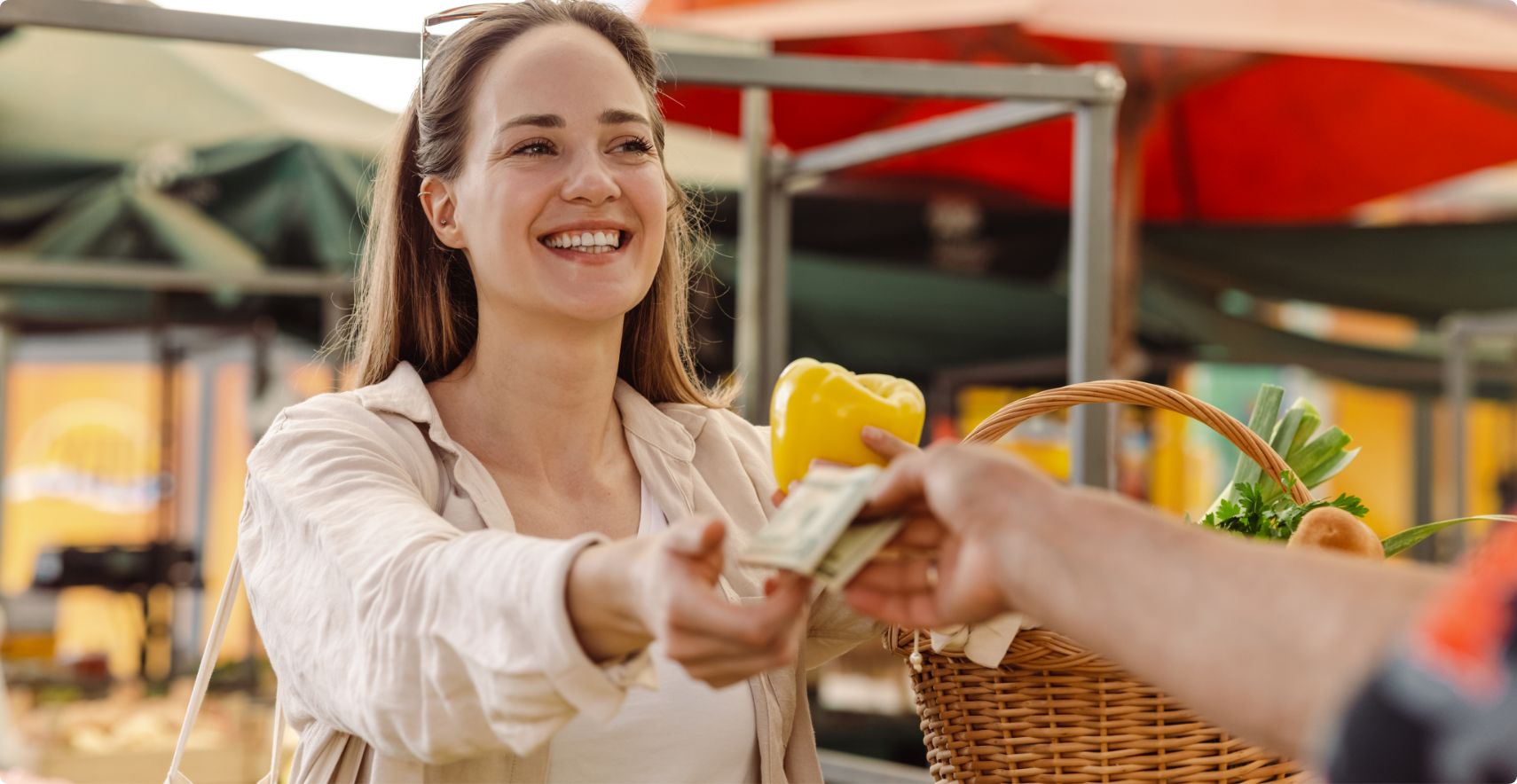 A customer paying cash at a market stall