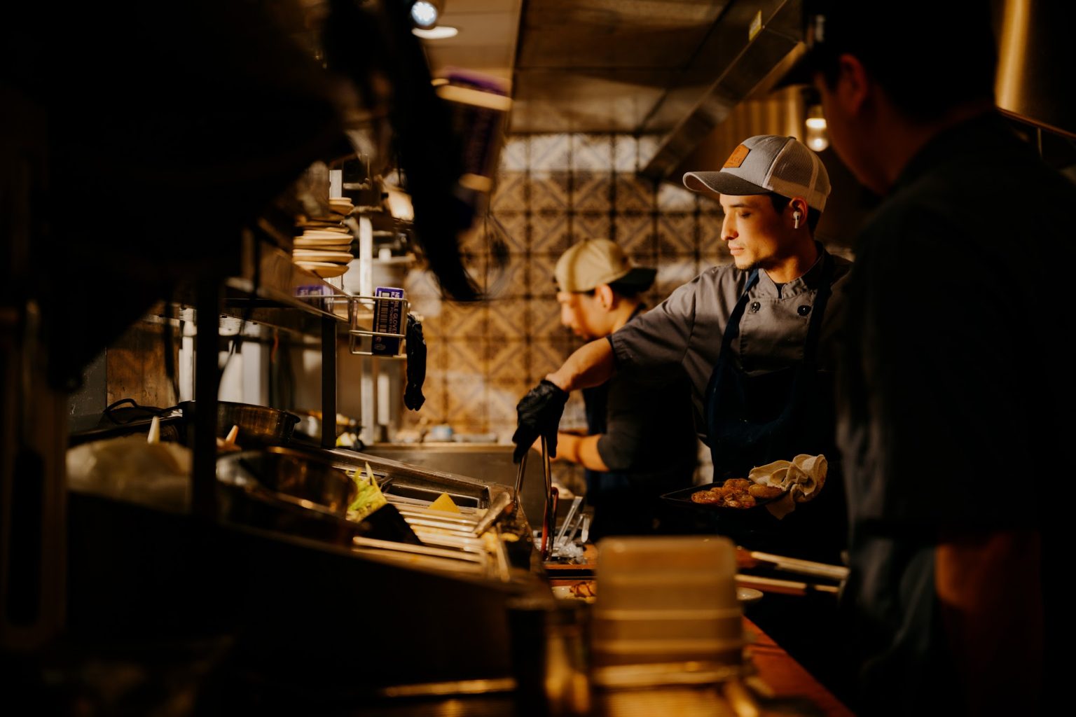 Guests enjoying a night out in a moody bar interior