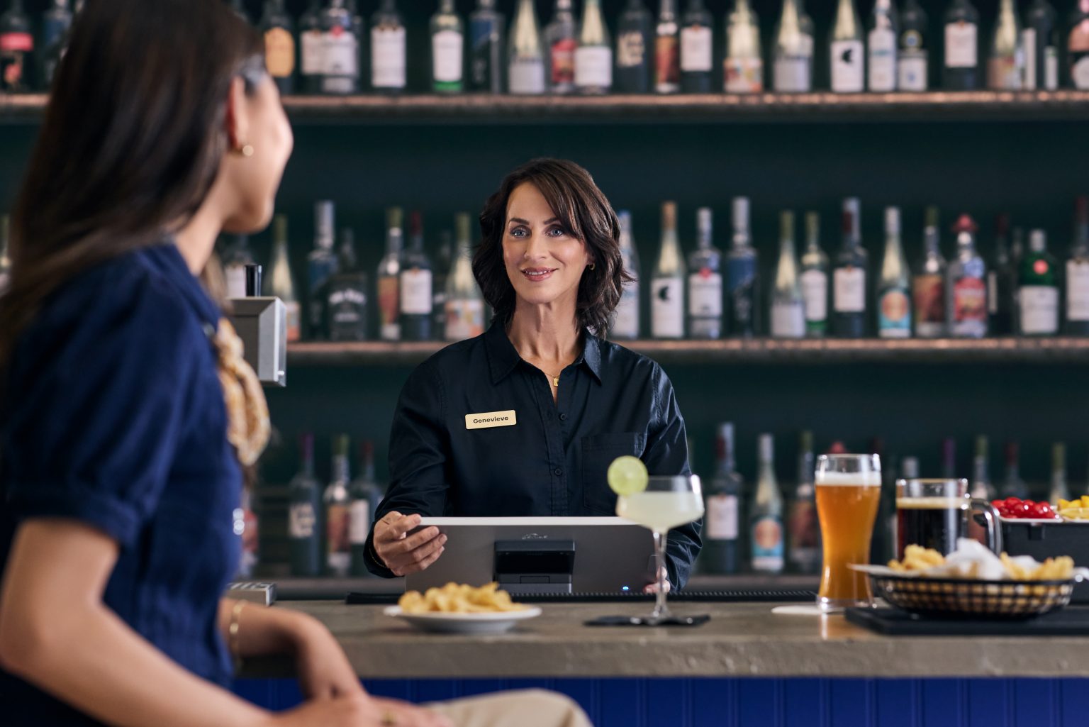Bartender turning the Genius screen to a guest