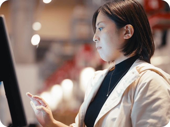 A guest placing her order at a self-ordering kiosk
