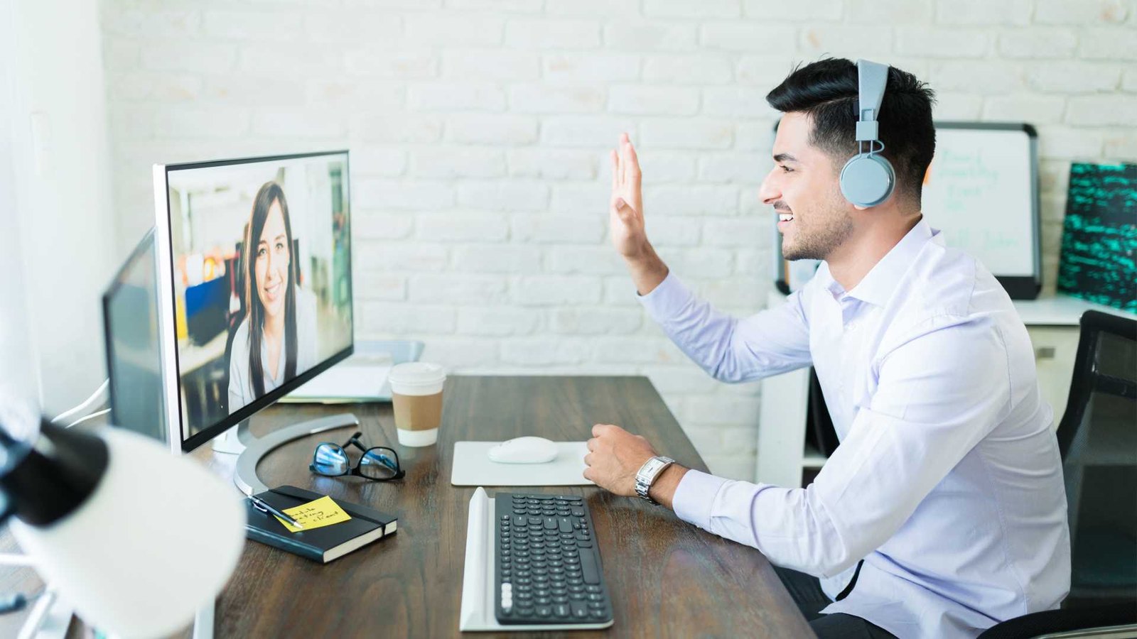 A trainer running a live Genius training session from their desk